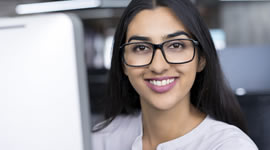 A smiling woman at her computer